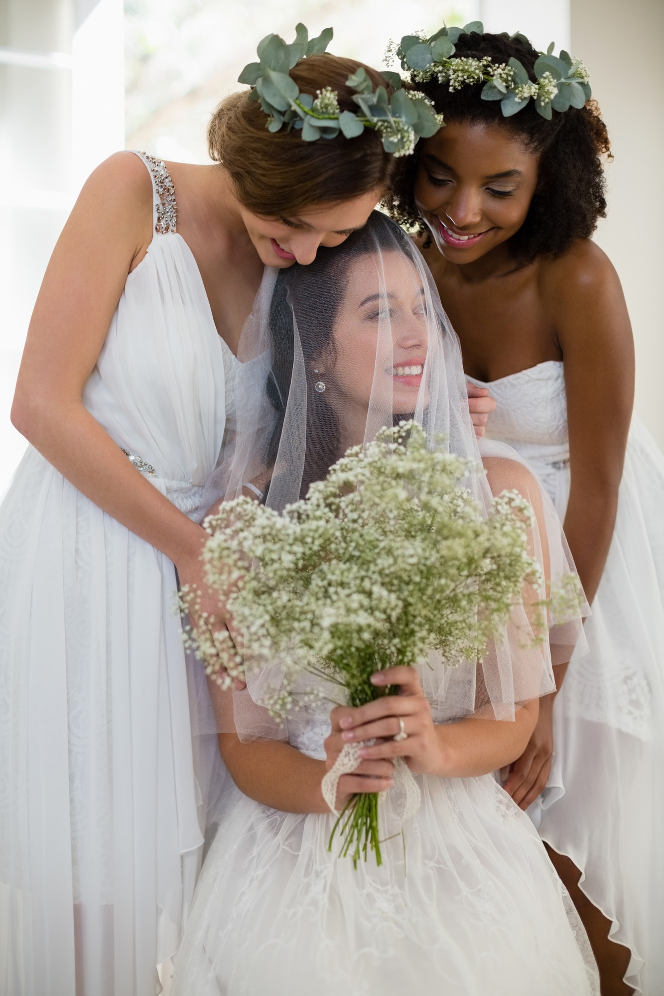 Bride interacting with bridesmaid at home